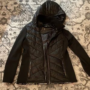 Black Calvin Klein puffer jacket with hood and fabric sleeves. Size Large